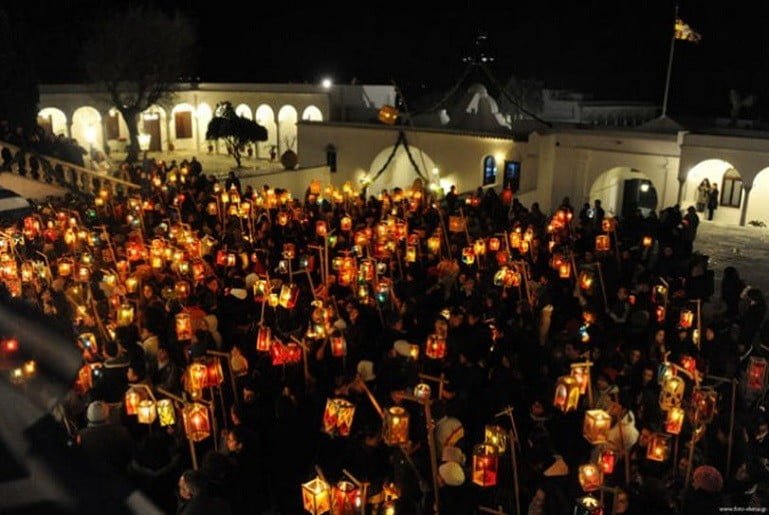 The “Fanarakia” (lanterns) of Tinos - Gastronomy Tours people front the church and holding illuminated lamps at The “Fanarakia” (lanterns) of Tinos, Greece by night